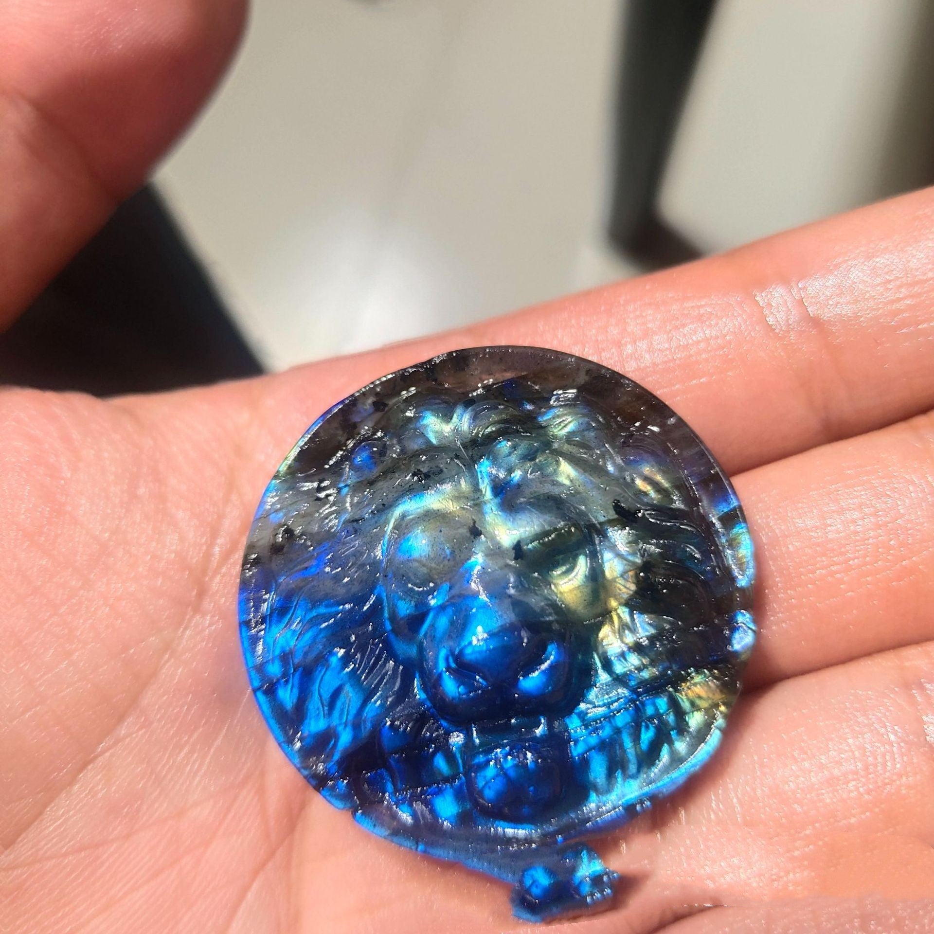 Blue and black marbled stone held in a hand