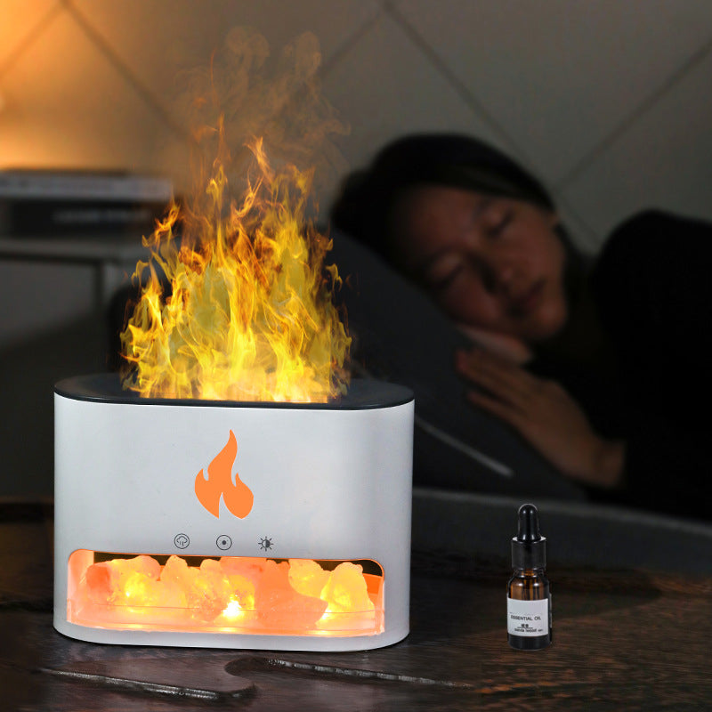 Flame-like device on a table with a person in the background