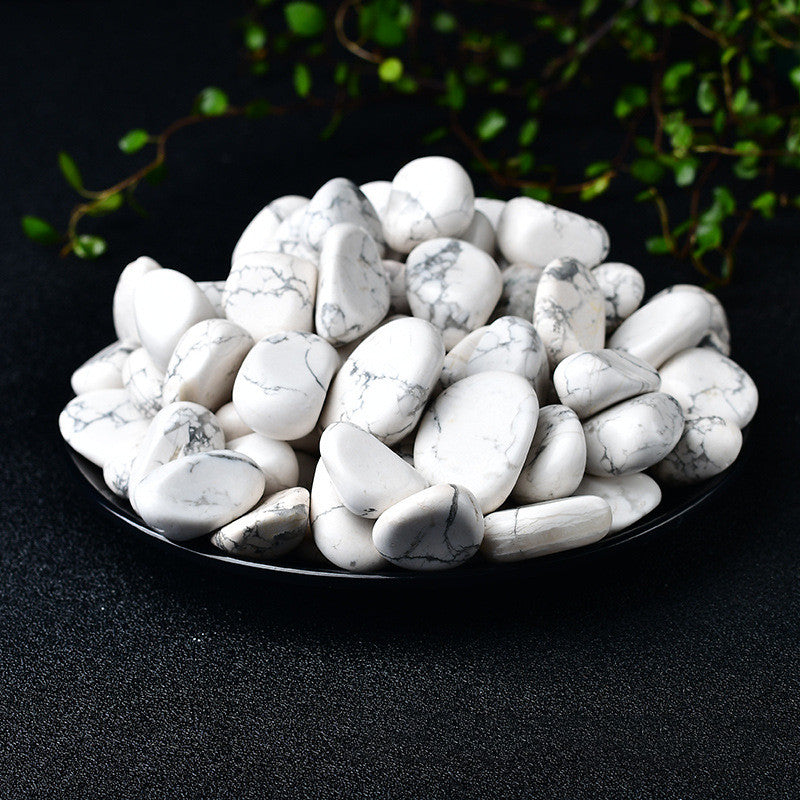White marbled stones on a black plate with a dark background