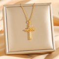 Gold cross necklace on a beige box with a soft background