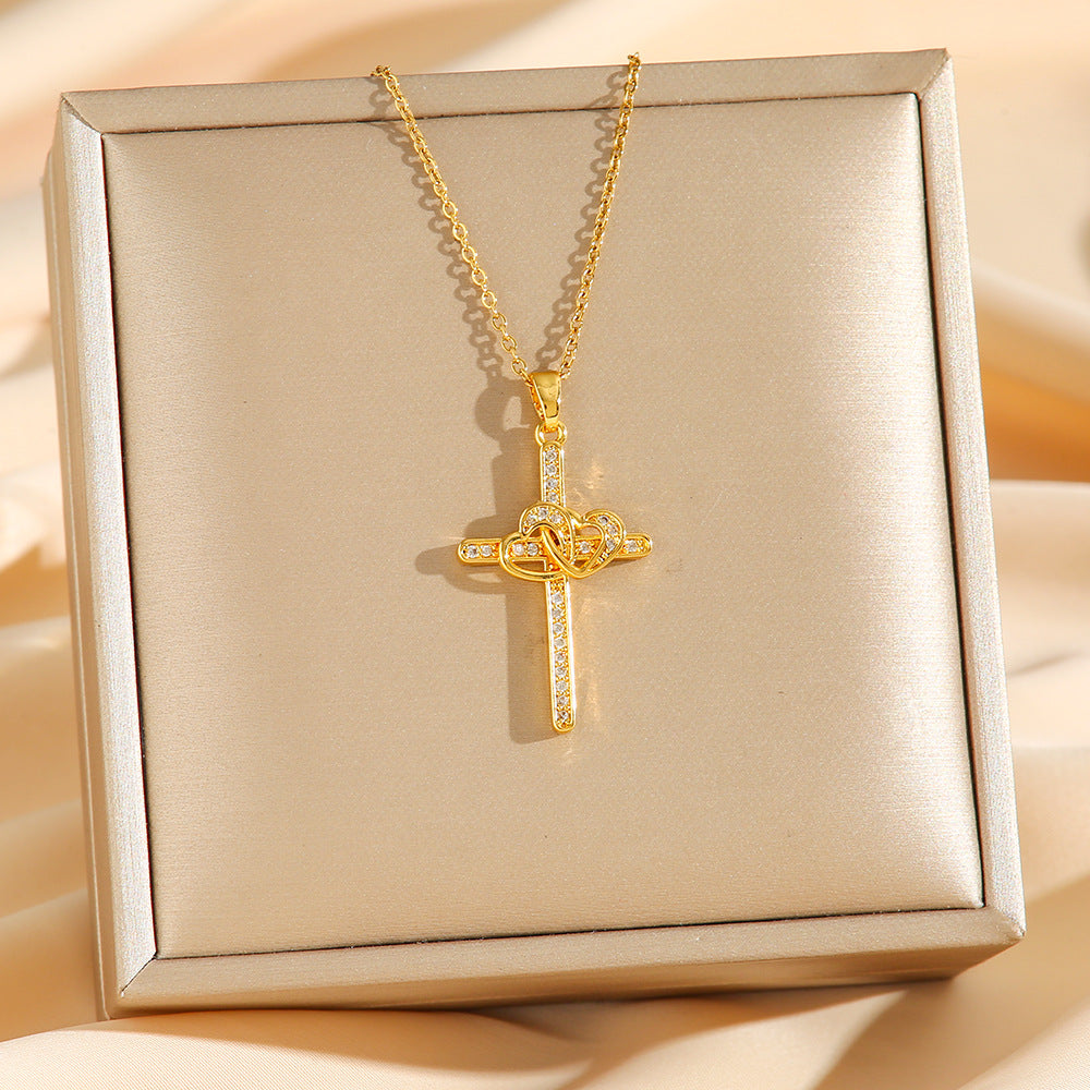 Gold cross necklace on a beige box with a soft background