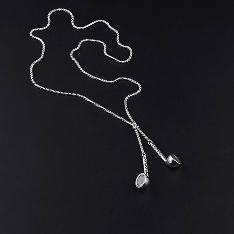 Silver necklace with a pendant on a black background
