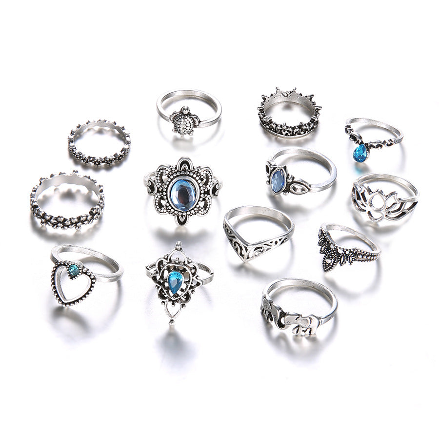 Collection of various silver rings with gemstones on a white background