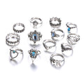 Collection of various silver rings with gemstones on a white background