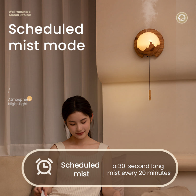 Woman sitting in a room with a wall-mounted diffuser labeled 'Scheduled mist mode'.