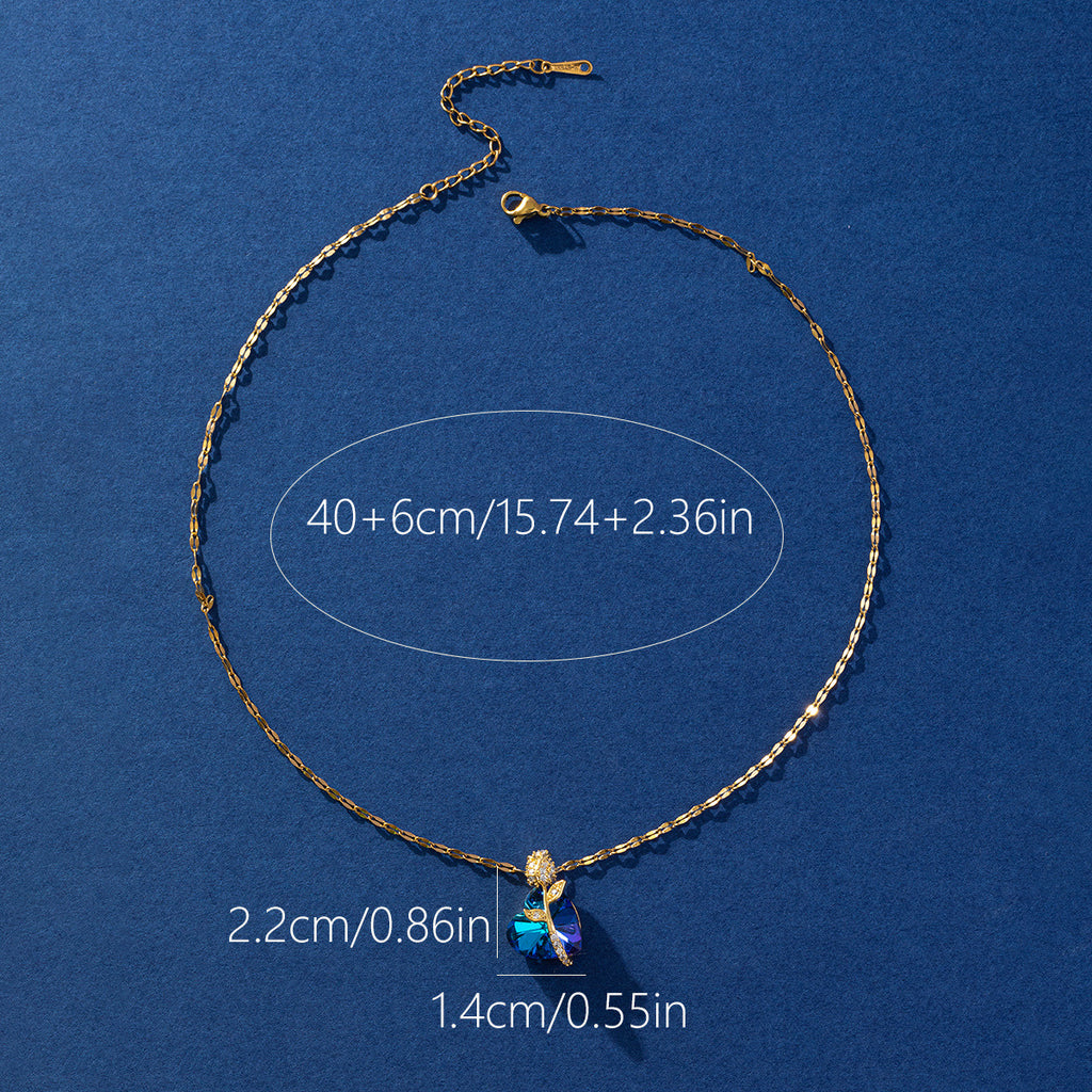 Gold necklace with a blue pendant on a blue background