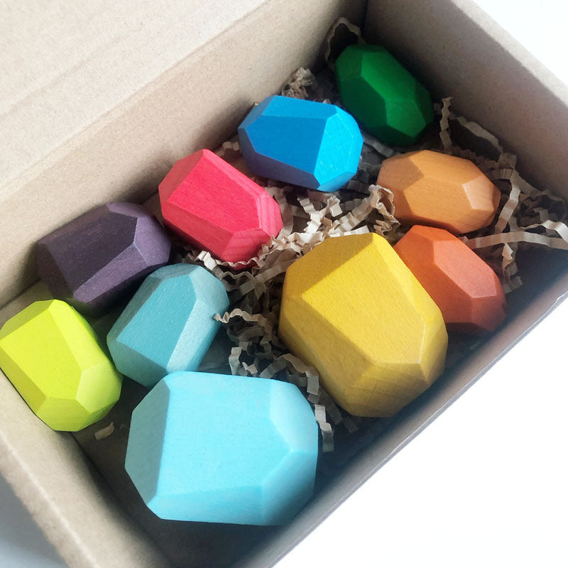 Colorful hexagonal crayons in a box with shredded paper