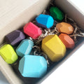 Colorful hexagonal crayons in a box with shredded paper