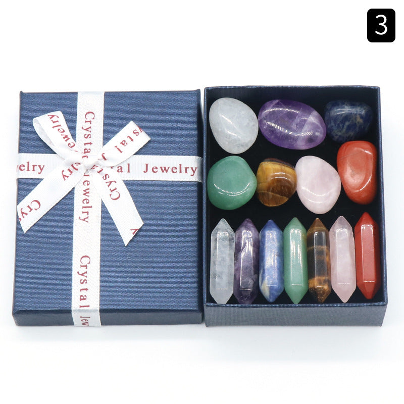 Box of crystal jewelry with stones and crystals on a white background