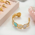 Gold bracelet with decorative elements on a light surface