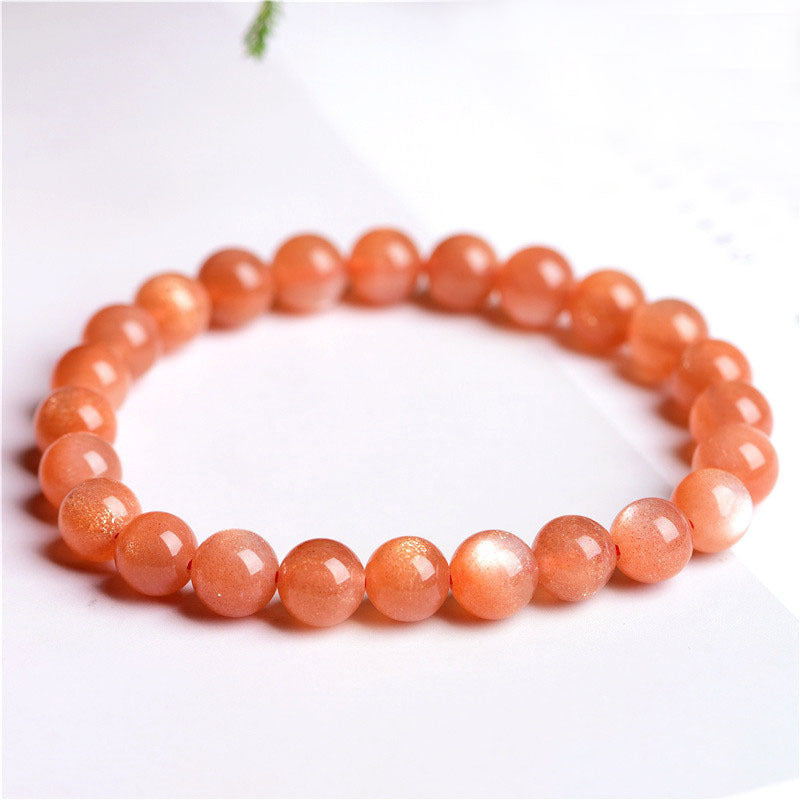 Orange beaded bracelet on a white background