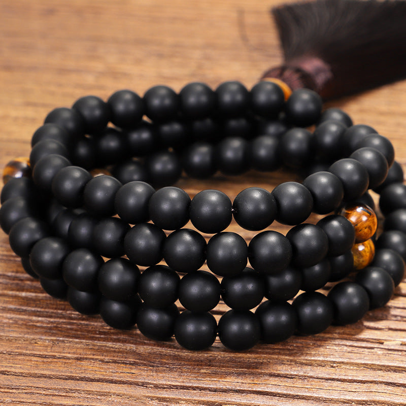 Black beaded bracelet on a wooden surface