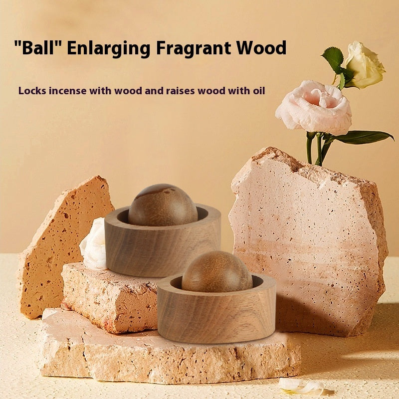 Wooden incense holders with stones and a flower on a beige background