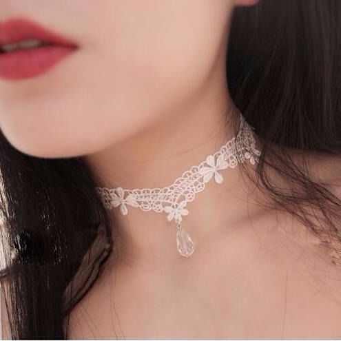 Close-up of a woman wearing a delicate lace choker necklace.