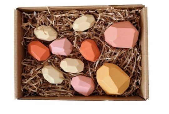 Set of colorful geometric candles in a box with straw-like material
