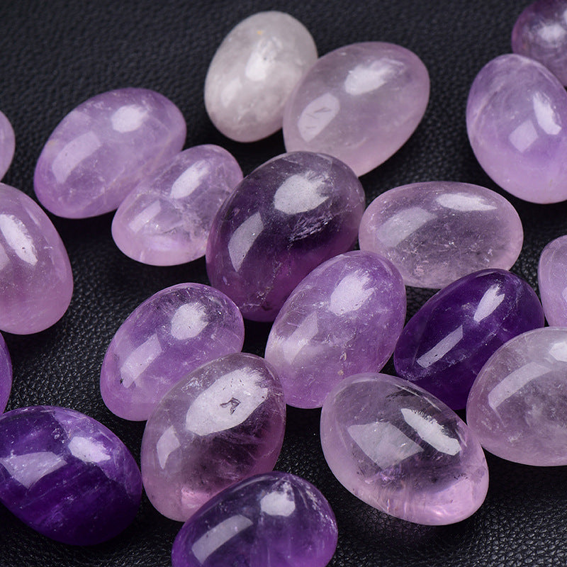Purple and pink gemstones on a dark surface