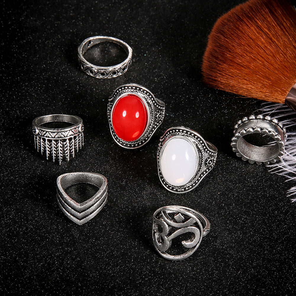 Collection of silver rings with different designs on a black background