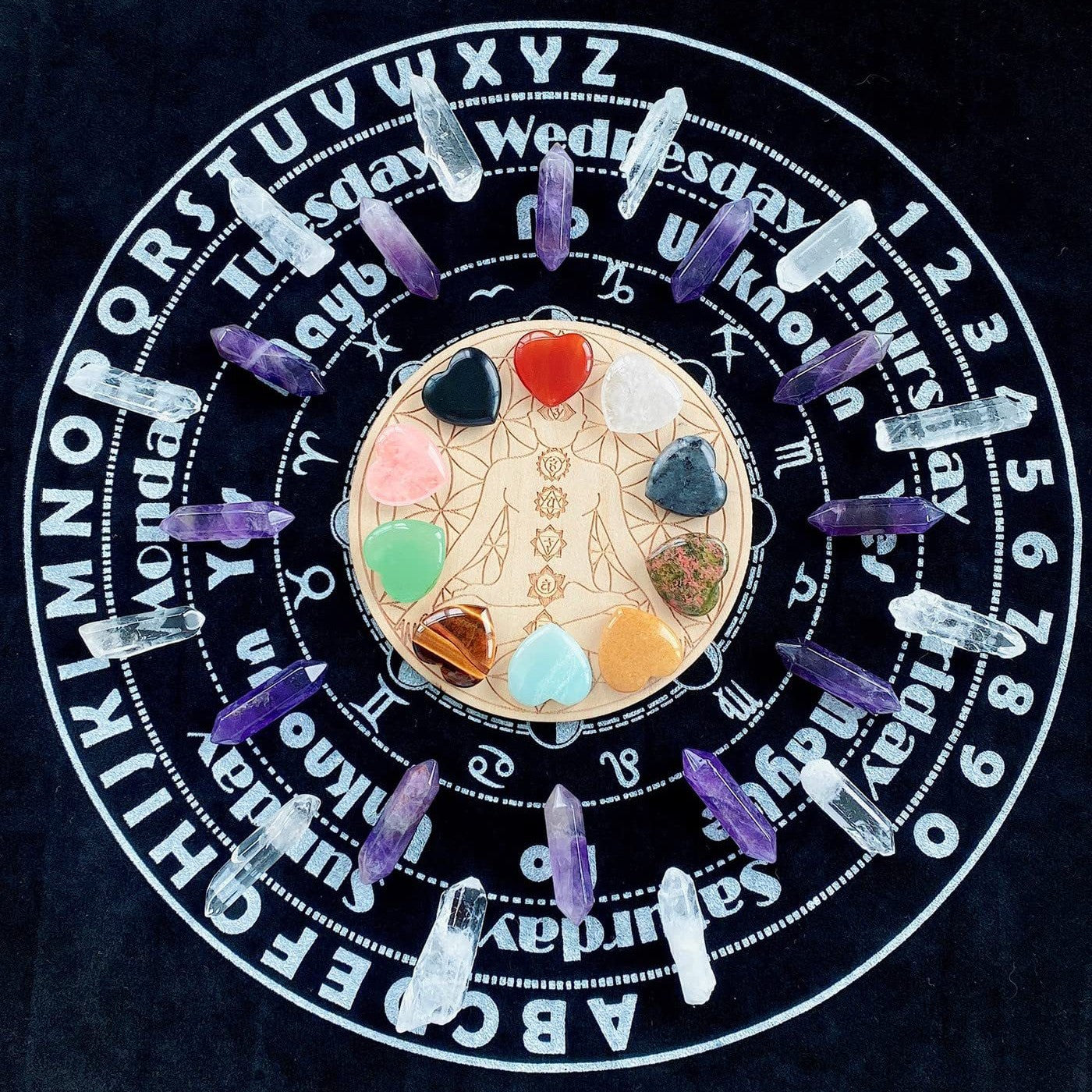 Crystal grid with colored stones on a black background with white text