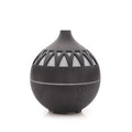 Black essential oil diffuser with geometric design on a white background