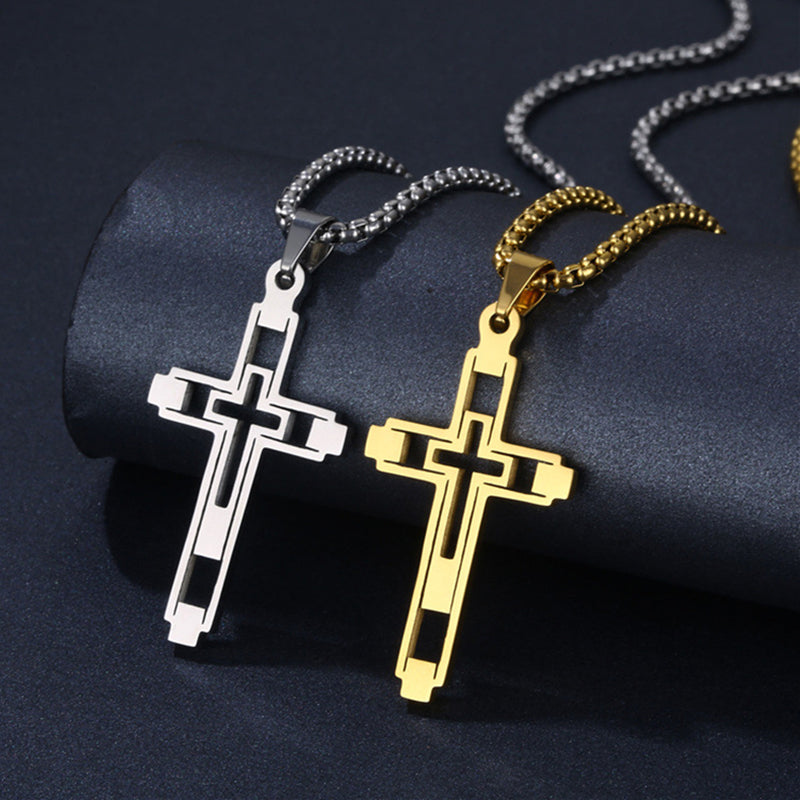 Two cross necklaces, one silver and one gold, on a dark background.