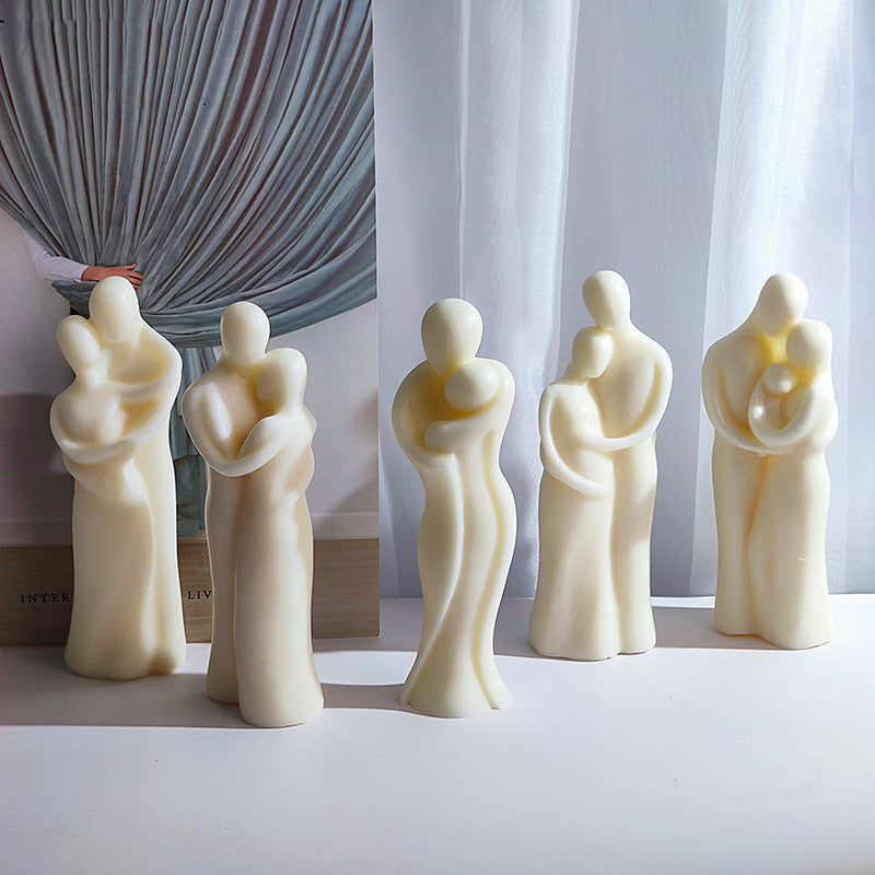 Five white ceramic figures holding hands on a light surface with a neutral background