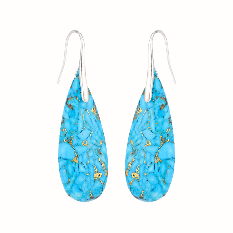 Turquoise blue earrings with gold accents on a white background