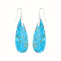 Turquoise blue earrings with gold accents on a white background