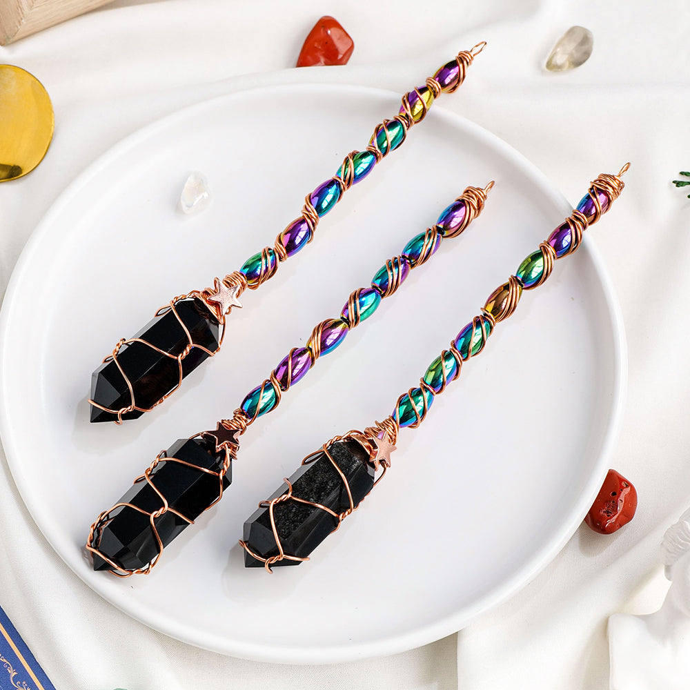 Colorful beaded earrings with black stone ends on a white plate