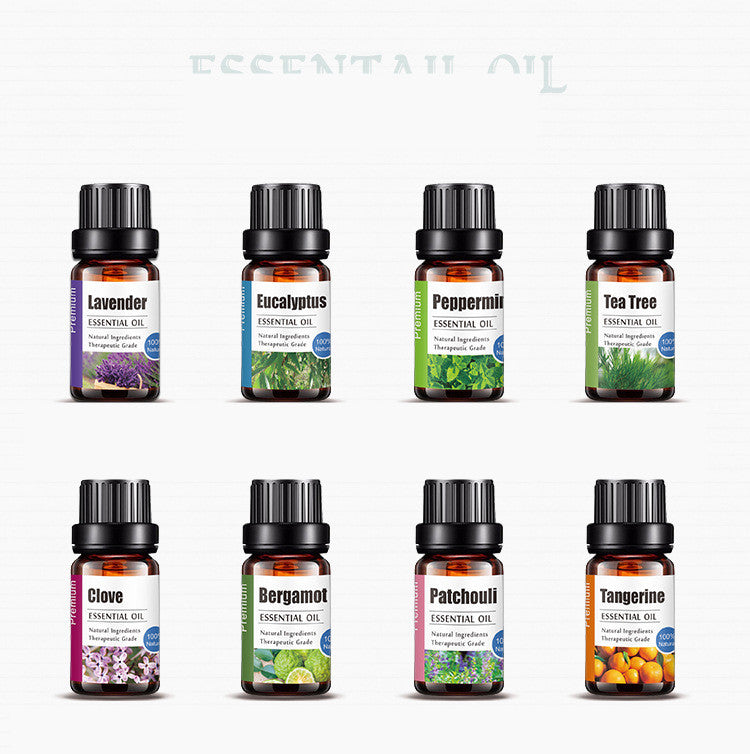 Collection of essential oil bottles with labels on a white background
