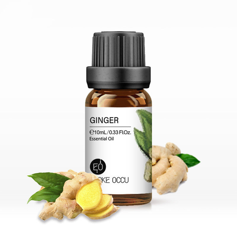 Bottle of ginger essential oil with ginger root and leaves on a white background