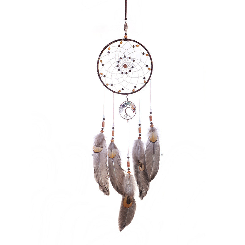 Dreamcatcher with feathers and beads on a white background