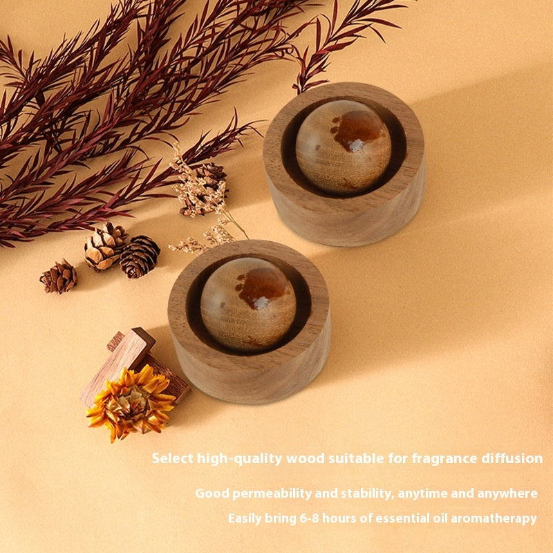 Two wooden containers with spherical objects on a beige surface with decorative elements.