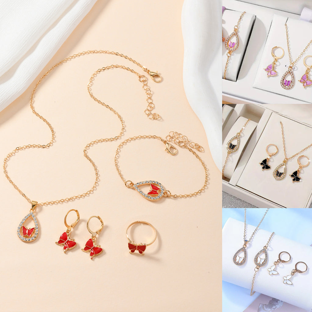 Gold jewelry set with necklaces, bracelets, earrings, and rings on a beige background.