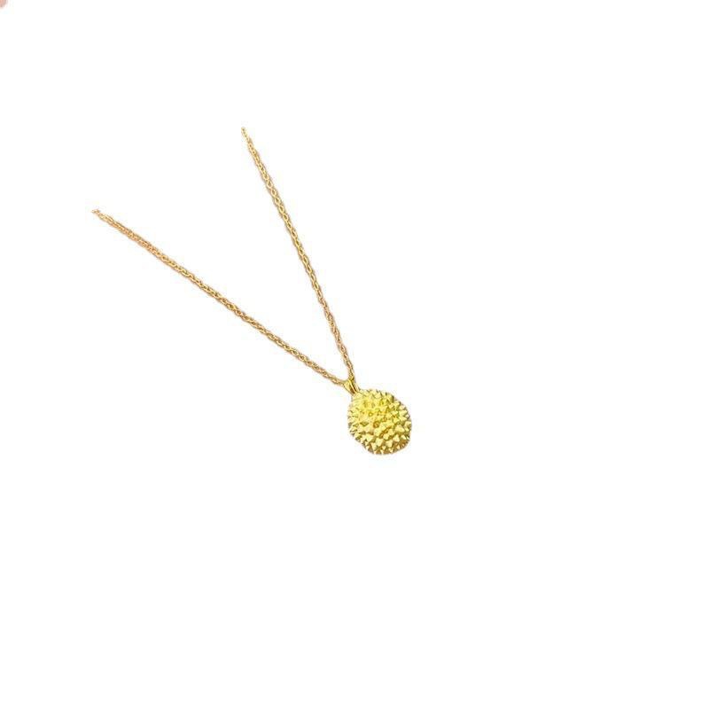 Gold necklace with a textured pendant on a white background