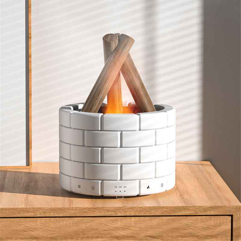 Small indoor fireplace with woven design and wooden logs on a wooden surface.