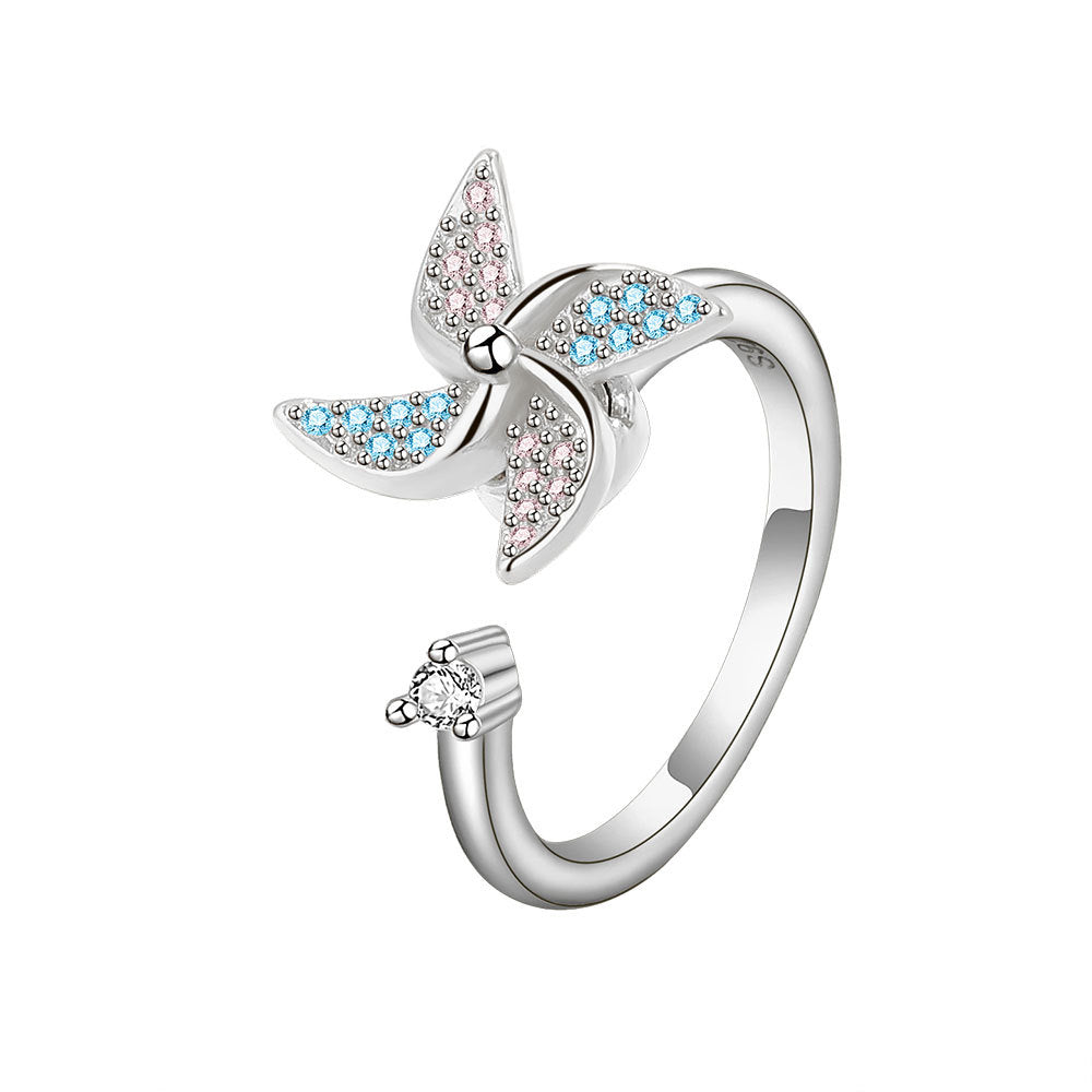Silver butterfly ring with blue gemstones on a white background