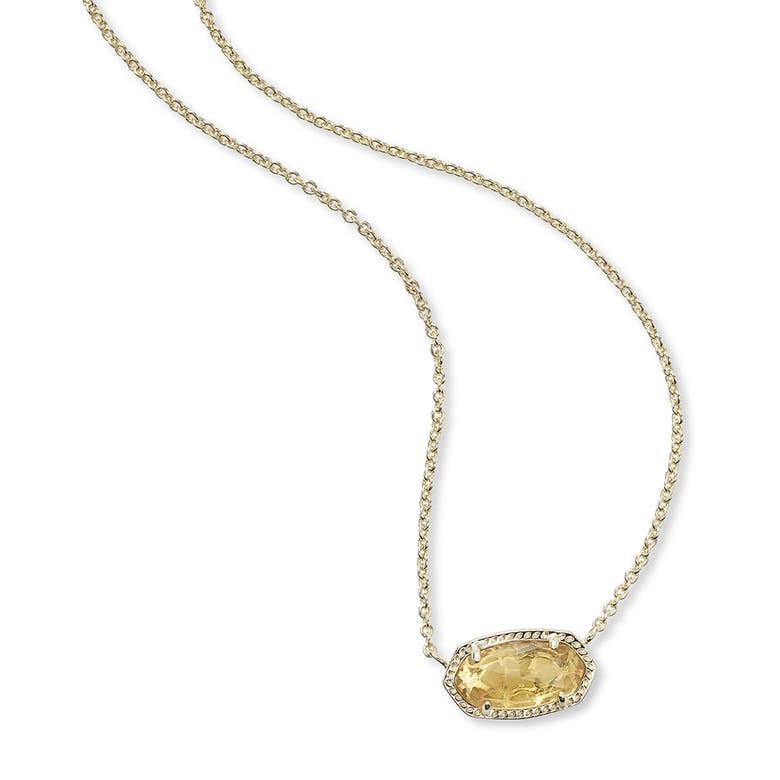 Gold necklace with a yellow pendant on a white background