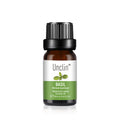 Bottle of Unclin basil essential oil on a white background