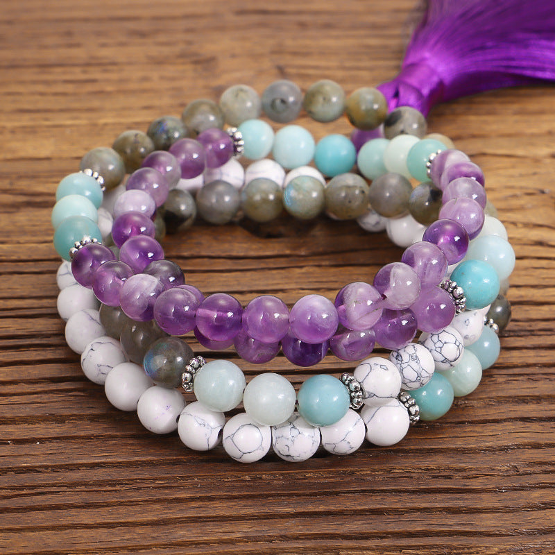 Stack of multicolored beaded bracelets on a wooden surface