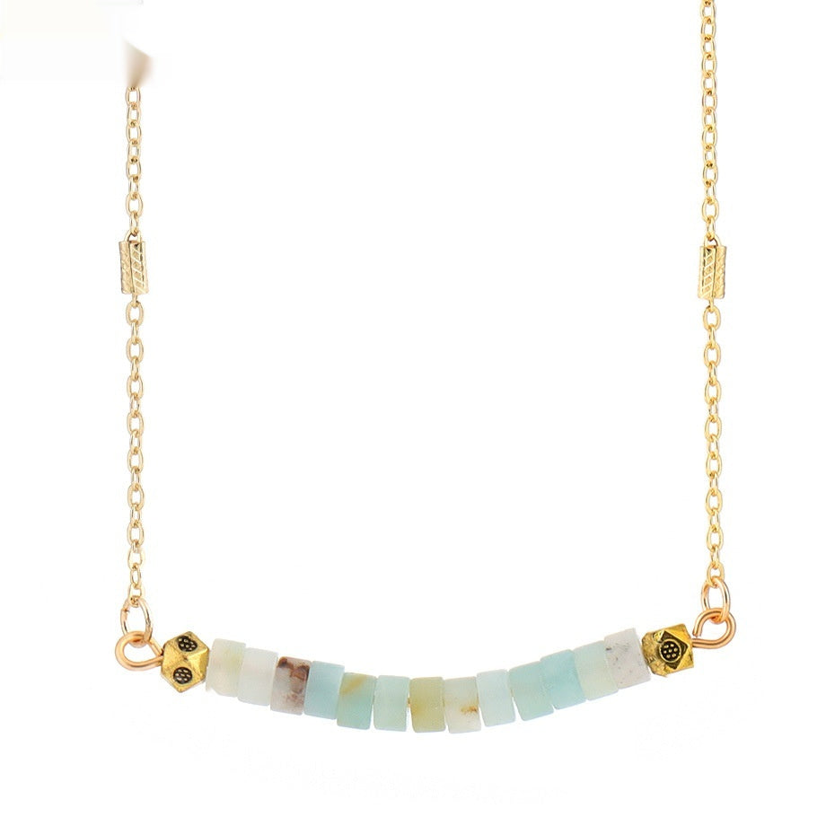 Necklace with gold chain and multicolored beads on a white background