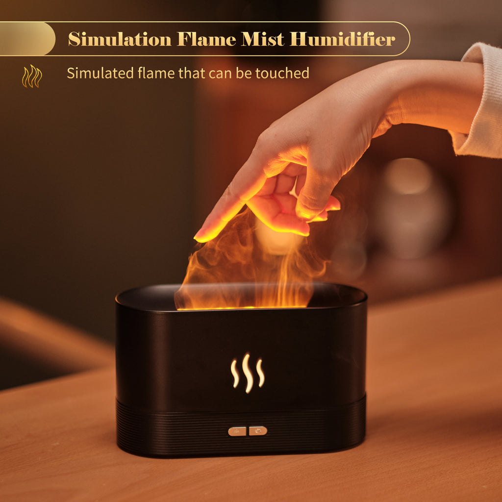 Simulation flame mist humidifier with a hand touching the flame-like mist on a wooden surface.
