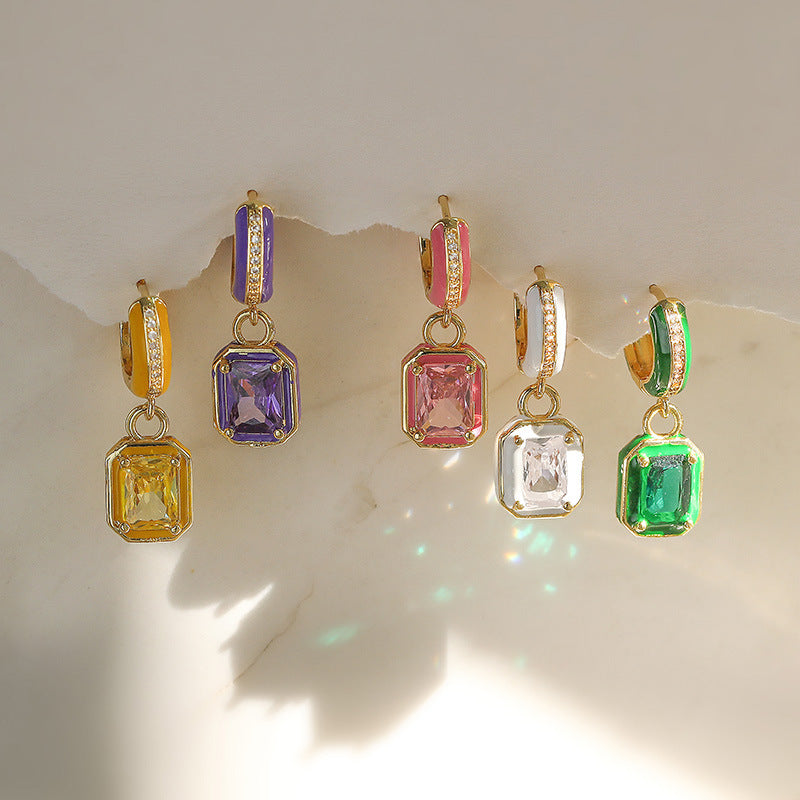 Set of five colorful gemstone earrings on a light background