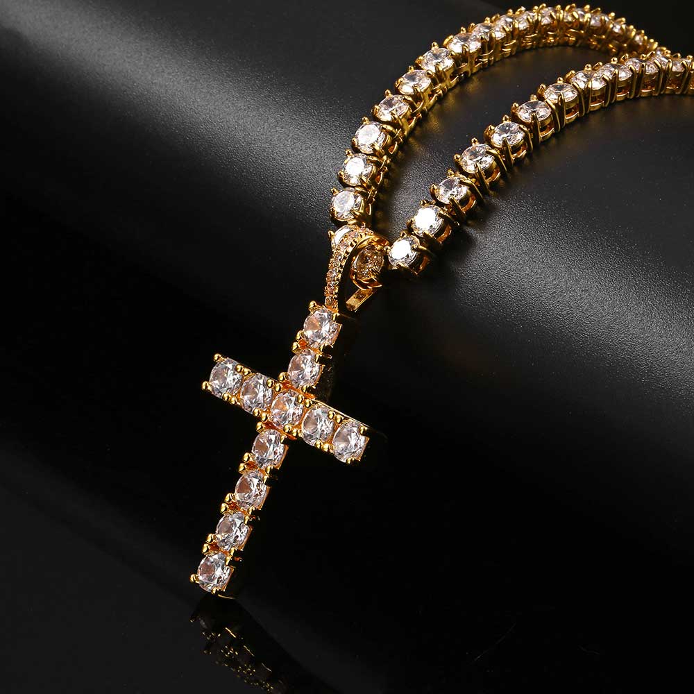 Gold necklace with a cross pendant on a black background