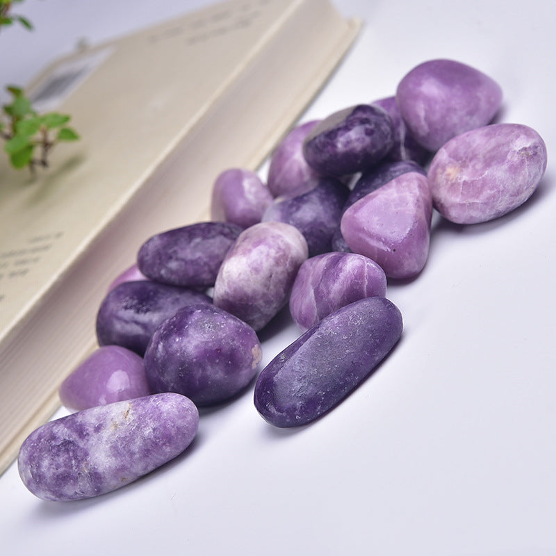 Purple stones on a white surface with a blurred background