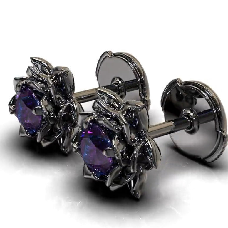 Pair of silver earrings with purple gemstones on a white background
