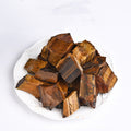 Brown wooden blocks on a white plate with a white background