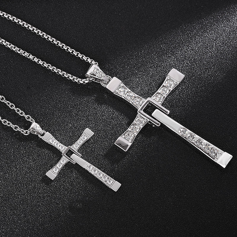 Silver cross-shaped pendants on black background