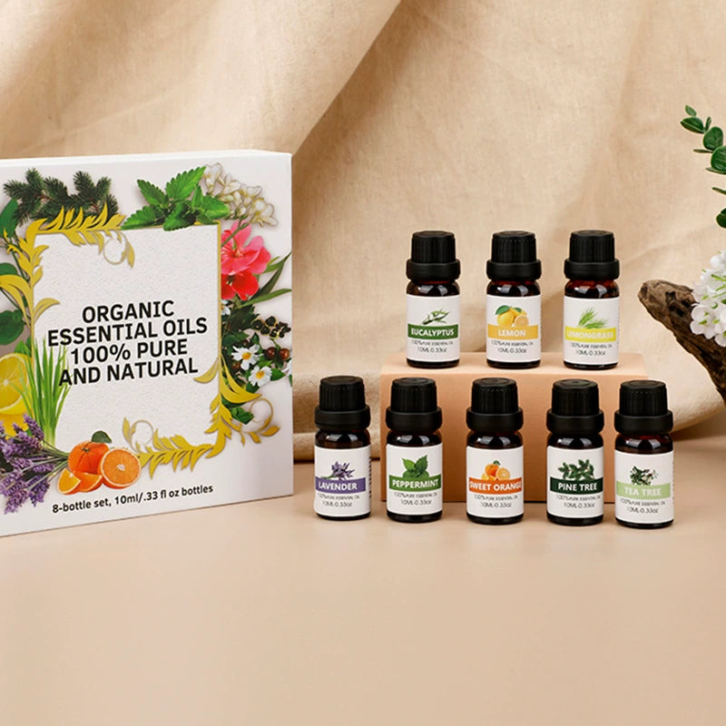 Set of organic essential oils with a packaging box on a beige background