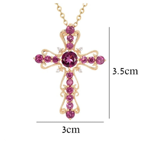 Gold cross necklace with pink gemstones and measurements on a white background