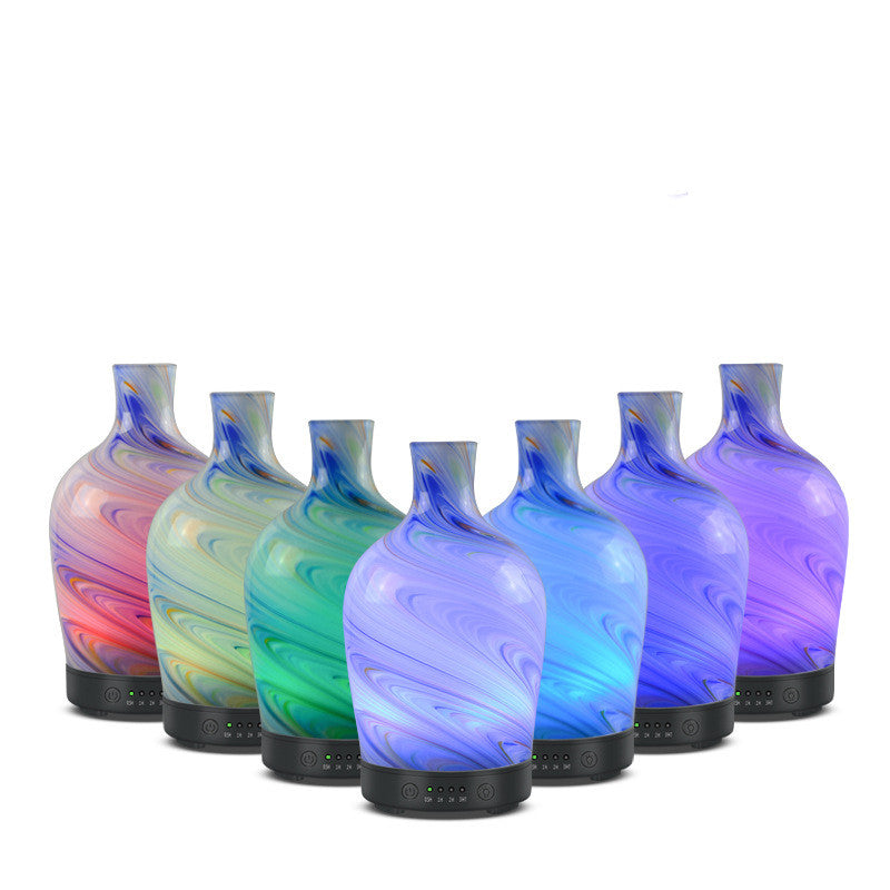 Set of colorful glass bottles with swirling patterns on a white background